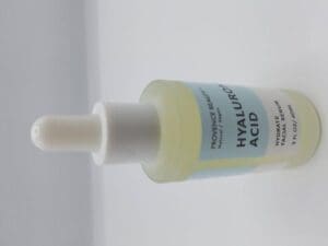 A bottle of PROVENCE BEAUTY HYALURONIC ACID HYDRATE FACIAL SERUM 2FL OZ/60ML on a white surface.