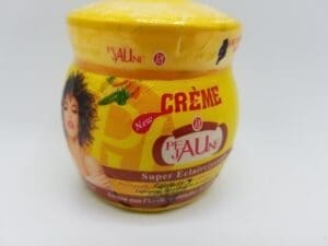 A jar of creme is sitting on the table.