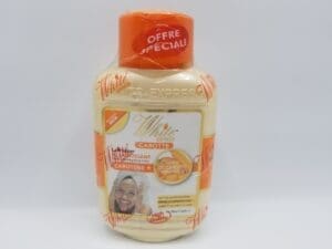 A jar of coffee and cream is sitting on the floor.