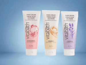 Three different hand creams are shown on a blue background.