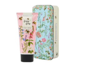 A tube of lotion and a tin with flowers on it.