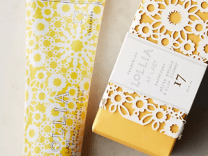 A yellow tube of lotion next to a box.