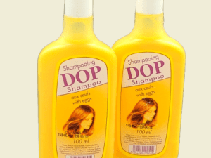 Two bottles of shampoo with a picture of a woman in the background.